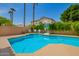 The backyard features a sparkling pool, mature trees, and privacy fencing at 1014 W Mulberry Dr, Chandler, AZ 85286