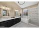 Bright bathroom with double vanity, soaking tub, and frameless glass shower at 10623 E Acacia Dr, Scottsdale, AZ 85255