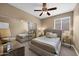 This primary bedroom is a cozy retreat with a ceiling fan, closet, and large window for natural light at 10623 E Acacia Dr, Scottsdale, AZ 85255