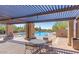 Relaxing pool area with shaded seating and lush desert landscaping at 10623 E Acacia Dr, Scottsdale, AZ 85255