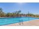 Large community pool with ample lounge seating and desert surroundings at 10623 E Acacia Dr, Scottsdale, AZ 85255