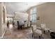 Open-concept dining area with stylish chandelier and decorative wood accent wall at 10623 E Acacia Dr, Scottsdale, AZ 85255