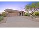 Charming single-Gathering home with desert landscaping, a two-car garage and a long driveway at 10623 E Acacia Dr, Scottsdale, AZ 85255