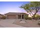 Exterior home view with desert landscaping, natural rock accents, and a cozy front porch at 10623 E Acacia Dr, Scottsdale, AZ 85255