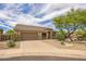 Charming single-story home with desert landscaping, stone accents, and a two-car garage at 10623 E Acacia Dr, Scottsdale, AZ 85255
