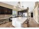 Modern kitchen with a large marble island, stainless steel appliances, and dark wood cabinetry at 10623 E Acacia Dr, Scottsdale, AZ 85255