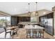 Bright kitchen featuring a large island, pendant lighting, stainless steel appliances, and breakfast area at 10623 E Acacia Dr, Scottsdale, AZ 85255