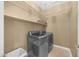 Convenient laundry room equipped with shelving and stainless steel washer and dryer at 10623 E Acacia Dr, Scottsdale, AZ 85255