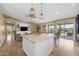 Open floor plan with a kitchen island, living room, and views of the backyard and the pool at 10623 E Acacia Dr, Scottsdale, AZ 85255