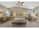 Serene main bedroom with a ceiling fan, soft lighting, and neutral color palette at 10623 E Acacia Dr, Scottsdale, AZ 85255