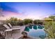 Secluded pool area with comfortable lounge chairs, lush landscaping, and privacy at 10623 E Acacia Dr, Scottsdale, AZ 85255