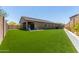 Large backyard featuring synthetic grass and a playset at 10949 N 183Rd Dr, Surprise, AZ 85388