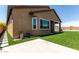 Corner of the yard with synthetic grass, a view of the covered patio and adjacent planters at 10949 N 183Rd Dr, Surprise, AZ 85388