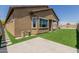 Exterior view showcasing the backyard with artificial turf, patio, planters, and lush landscaping at 10949 N 183Rd Dr, Surprise, AZ 85388