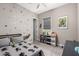 Bedroom boasts stylish decor, gray carpet, fun character wallpaper, and window with blinds at 10949 N 183Rd Dr, Surprise, AZ 85388