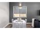 Bright dining area with a modern light fixture features a white table and chairs at 10949 N 183Rd Dr, Surprise, AZ 85388
