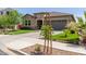 Beautiful home with well manicured desert landscaping, tile roof, and paved driveway at 10949 N 183Rd Dr, Surprise, AZ 85388