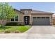 Charming home featuring stone accents, desert landscaping, and a spacious front yard at 10949 N 183Rd Dr, Surprise, AZ 85388