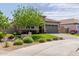 Beautiful single-story home showcasing desert landscaping, lush green grass, and a stone accent exterior at 10949 N 183Rd Dr, Surprise, AZ 85388