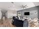 Spacious living room boasts wood floors, recessed lighting, modern ceiling fan, and contemporary furnishings at 10949 N 183Rd Dr, Surprise, AZ 85388