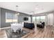 Open concept living room with dining area features wood floors and plenty of natural light at 10949 N 183Rd Dr, Surprise, AZ 85388