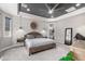 Cozy main bedroom features a king bed, modern ceiling fan, and designer accent wall at 10949 N 183Rd Dr, Surprise, AZ 85388