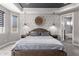 Comfortable main bedroom features decorative wall, stylish pendants, and view to bright ensuite bathroom at 10949 N 183Rd Dr, Surprise, AZ 85388