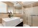 Modern bathroom with stylish sink, neutral tile, and glass enclosed shower at 1115 E Carter Dr, Tempe, AZ 85282