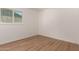 This room offers wood-look flooring, bright white walls, and natural light at 1115 E Carter Dr, Tempe, AZ 85282