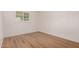 Neutral bedroom with wood-look flooring and a view of the backyard at 1115 E Carter Dr, Tempe, AZ 85282