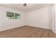 Neutral bedroom with modern ceiling light and durable wood-look flooring, offering a tranquil space at 1115 E Carter Dr, Tempe, AZ 85282