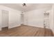 A spacious, light bedroom with wood-look flooring and access to closet and bathroom at 1115 E Carter Dr, Tempe, AZ 85282