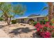 Single story home with a spacious driveway and desert landscaping under a clear blue sky at 1115 E Carter Dr, Tempe, AZ 85282