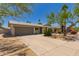Single story home with a spacious driveway and desert landscaping under a clear blue sky at 1115 E Carter Dr, Tempe, AZ 85282
