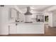 Bright, modern kitchen featuring stainless steel appliances, a large island, and sleek white cabinetry at 1115 E Carter Dr, Tempe, AZ 85282