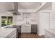 Well-lit kitchen with stainless steel appliances, white cabinetry, and a view to the backyard at 1115 E Carter Dr, Tempe, AZ 85282
