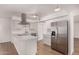 Modern kitchen featuring stainless steel appliances, a breakfast bar, and bright lighting at 1115 E Carter Dr, Tempe, AZ 85282