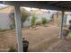 The backyard features a gravel area, surrounding block fence, and mature trees at 11770 W Aster Dr, El Mirage, AZ 85335