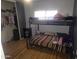 Functional bedroom featuring a bunk bed with hardwood floors and closet space at 11770 W Aster Dr, El Mirage, AZ 85335