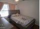 Serene bedroom with a wooden bed frame and warm, inviting ambiance at 11770 W Aster Dr, El Mirage, AZ 85335
