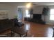 Spacious living room with natural light and a desert painting on the wall at 11770 W Aster Dr, El Mirage, AZ 85335