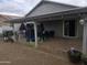 The covered patio has stone flooring and space for outdoor seating and entertaining at 11770 W Aster Dr, El Mirage, AZ 85335