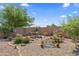 Beautiful backyard with decorative bridge, landscaping, patio umbrella, and gravel, creating a relaxing outdoor oasis at 1241 E Elm Rd, San Tan Valley, AZ 85140