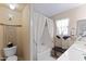 Bright bathroom features a separate tub with white curtains, complementing the neutral color scheme at 1241 E Elm Rd, San Tan Valley, AZ 85140