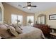 Bright bedroom features a large bed, dresser, and lots of natural light through big windows at 1241 E Elm Rd, San Tan Valley, AZ 85140