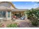 Inviting covered patio featuring comfortable seating, stylish decor, and a serene outdoor ambiance with garden views at 1241 E Elm Rd, San Tan Valley, AZ 85140