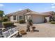 Charming single-story home featuring a desert-landscaped yard, bench, and neutral-tone exterior at 1241 E Elm Rd, San Tan Valley, AZ 85140