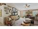 Comfortable living room with stylish furnishings, including a ceiling fan and TV at 1241 E Elm Rd, San Tan Valley, AZ 85140