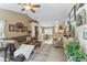Spacious living room with an open-concept design, ceiling fan, and neutral color scheme at 1241 E Elm Rd, San Tan Valley, AZ 85140
