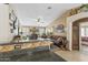 Bright living room showcasing tile floors, comfortable seating, and access to other areas of the home at 1241 E Elm Rd, San Tan Valley, AZ 85140